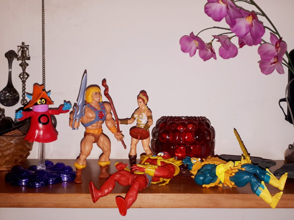 Beast-Man and Mer-Man are down and Teela rushes towards He-Man and Orko.