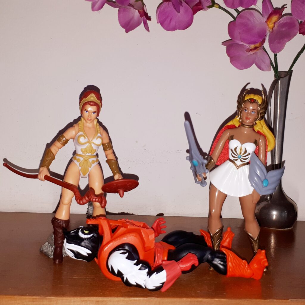 Teela and She-Ra stand over the fallen Stinkor.