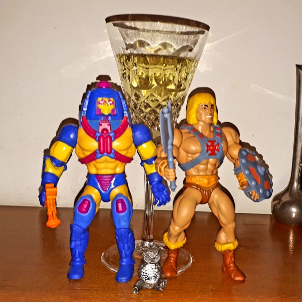 He-Man and Man-a-Faces celebrate with champagne