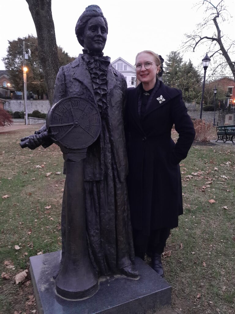 Leanna Renee Hieber with a statue of Ma Greene.