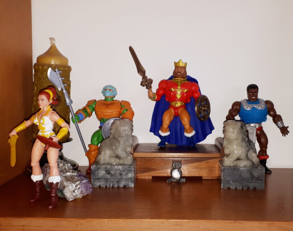 Teela stalks off, while King Randor, Clamp Champ and a palace guard look after her in confusion.