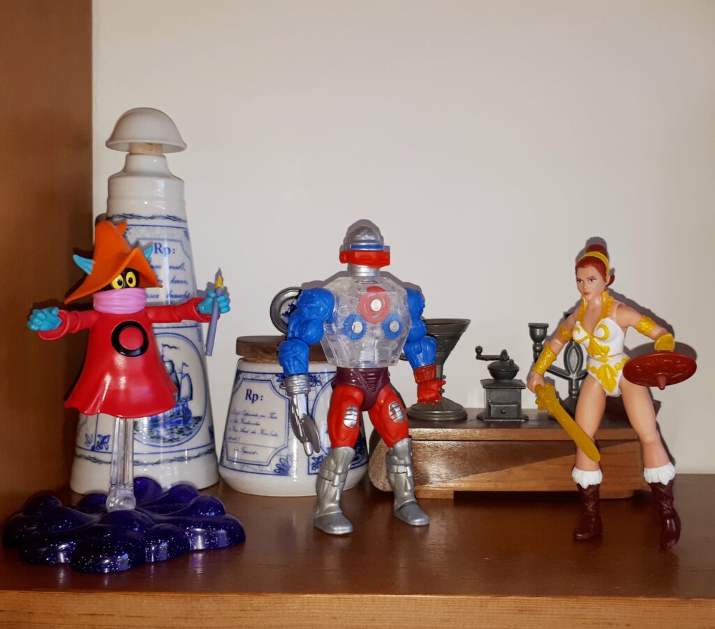 Teela shows off her new look to Orko and Roboto.