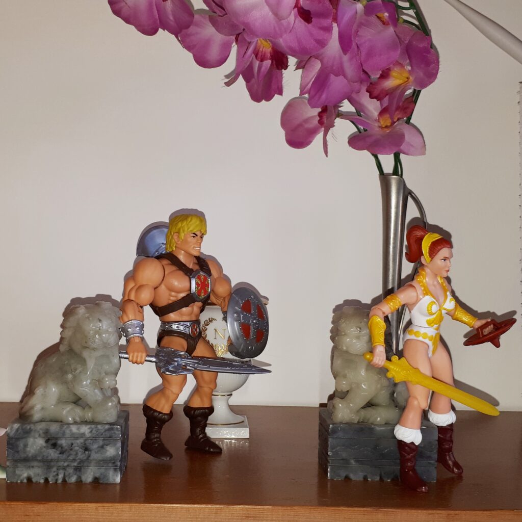 Teela stalks off, angry, while He-Man looks after her in confusion.