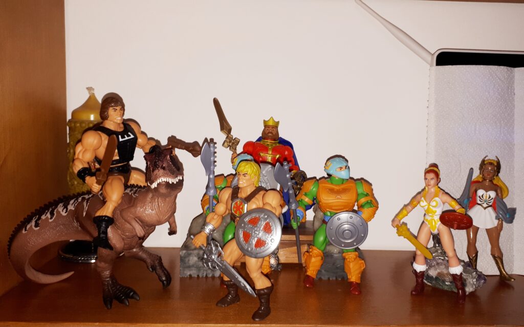 He-Man talks to Wun-Dar, while King Randor, Teela, She-Ra and two guards look on.