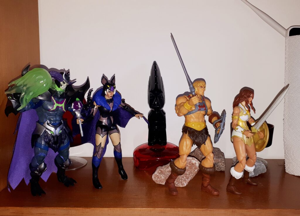He-Man and Teela escape, while Skeletor and Evil-Lyn fire magic blasts after them.