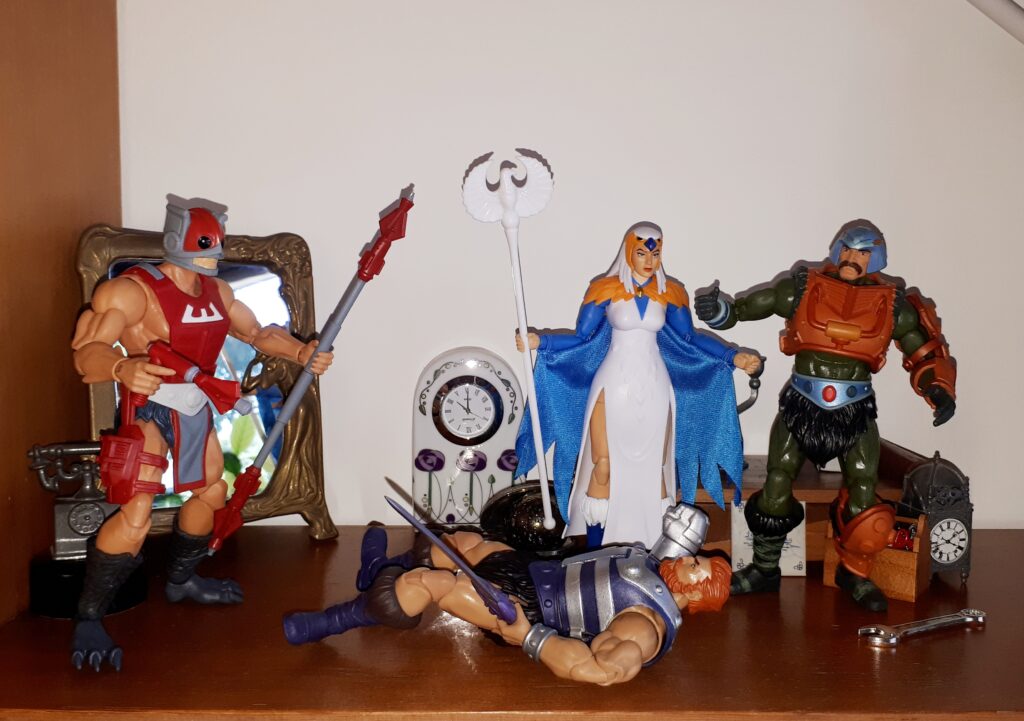 Zodac zaps Malcolm, while Duncan and the Sorceress look on.