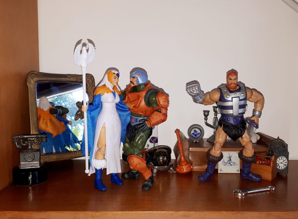 Duncan hugs the Sorceress, while Malcolm shakes his fist at the air.