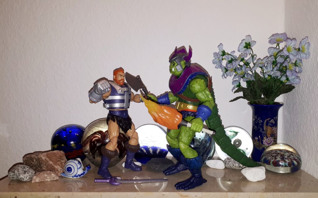 Whiplash holds Fisto at axe point.