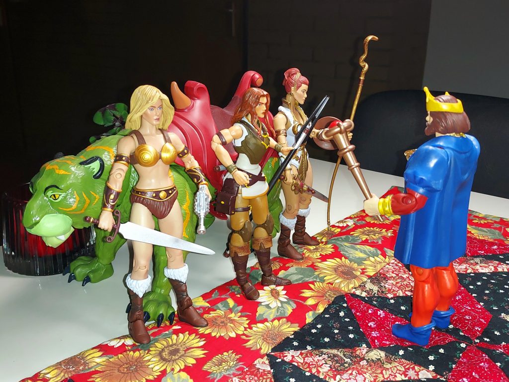 King Randor addresses three Teelas and Cringer.