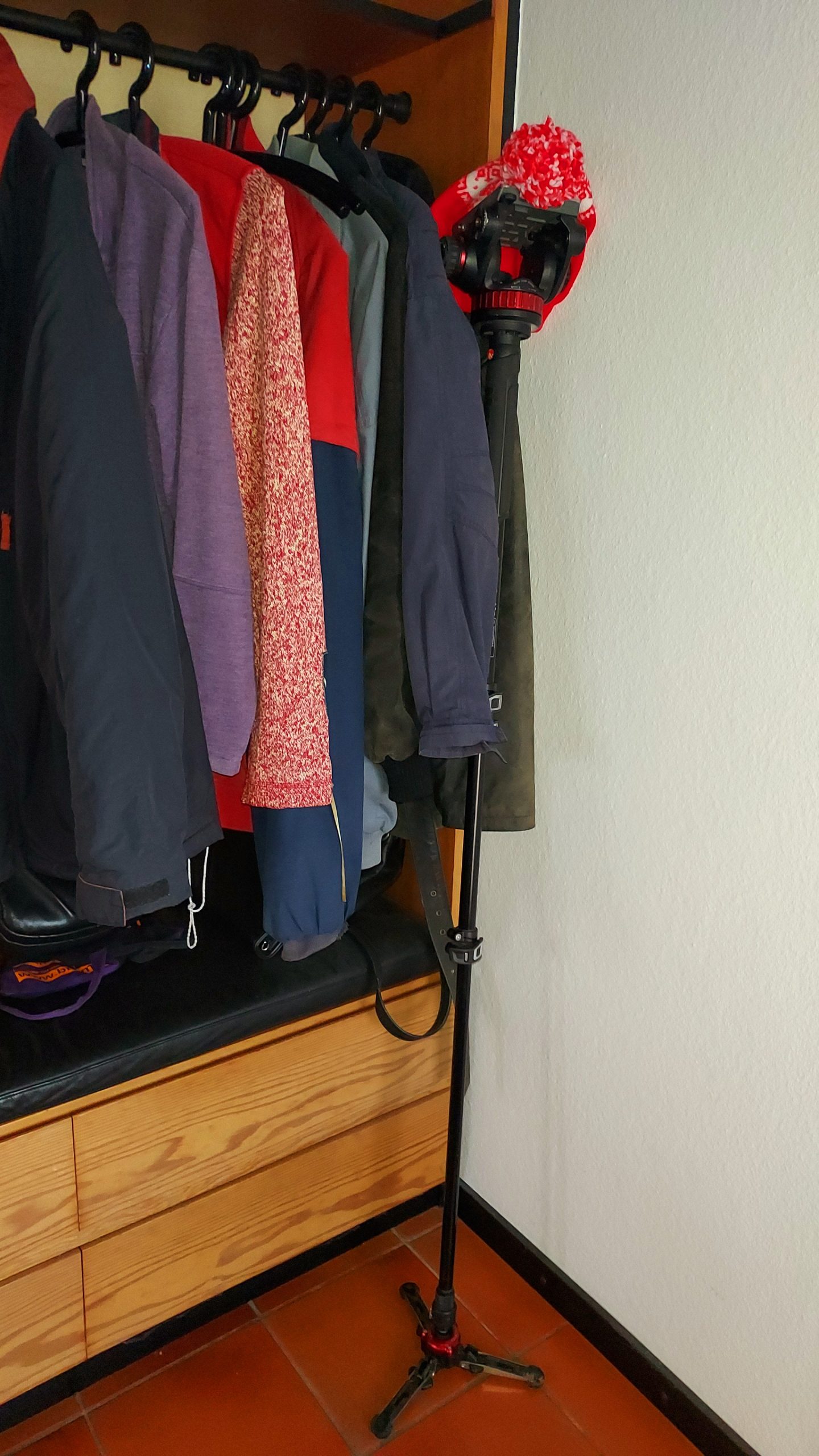 Tripod leaning against the coat rack
