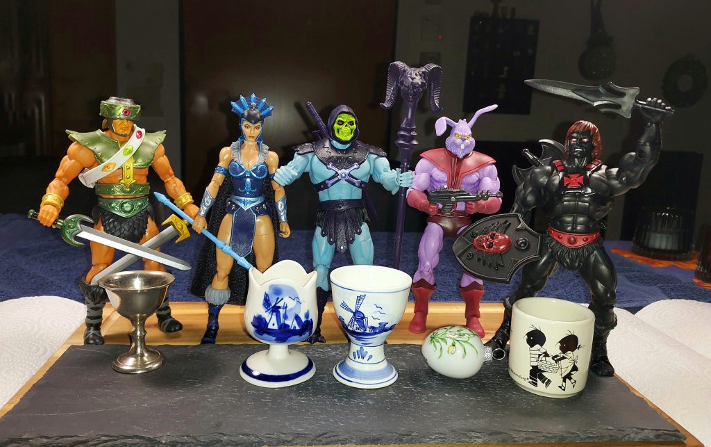 Tri-Klops, Evil-Lyn, Skeletor, Plundor and Anti-Eternia He-Man admire some vintage egg cups.